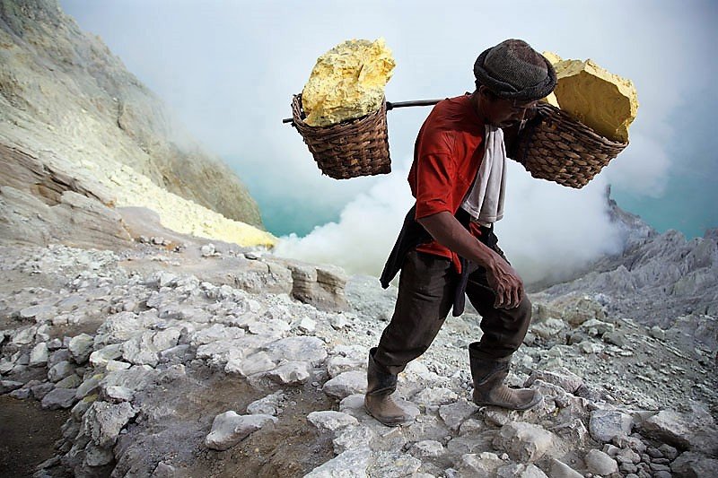 Sulfur collecting in the crater of Ijen Volcano, Java