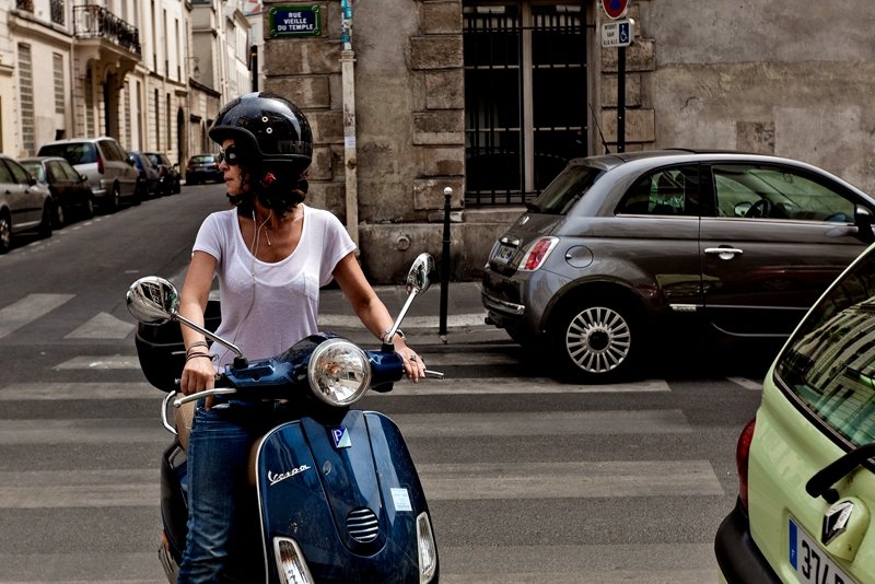 A traveler on a retro scooter in Paris.