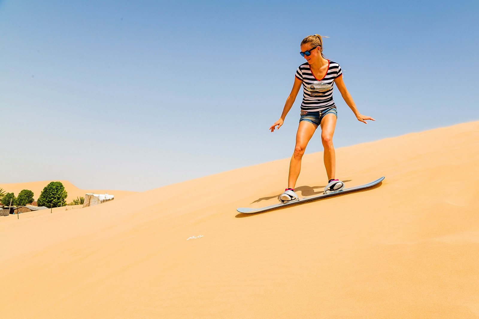 How to try sandboarding on sand dunes in Dubai