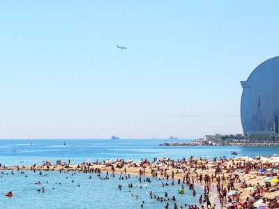 Take a sun tan on the Barceloneta Beach in Barcelona