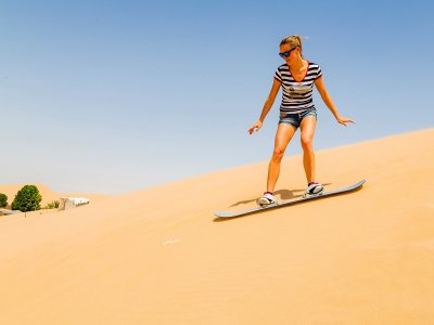Try sandboarding on sand dunes in Dubai