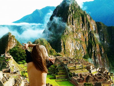 Take a naked selfie on the background of Machu Picchu in Aguas Calientes