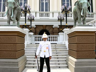 Take a selfie with a guard at the Grand Palace in Bangkok