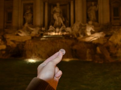 Throw a coin in the Trevi fountain in Rome