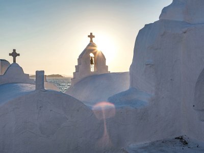 Ring the bell of the Panagia Paraportiani Church on Mykonos