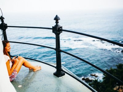 Climb to the top of the lighthouse on the edge of the island in Matara