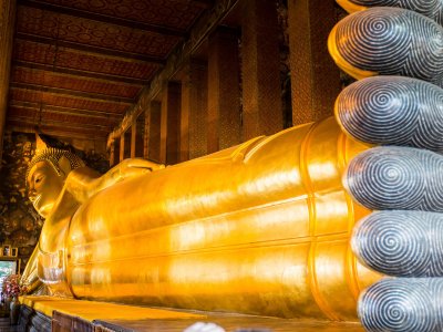Make a wish at the Temple of the Reclining Buddha in Bangkok